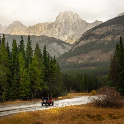 Jeep driving down a dirt road in Banff National Park, Alberta, Canada