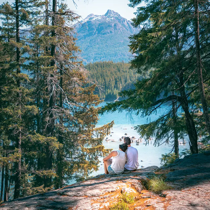 Couple sitting in next to Myra Falls in Vancouver Island